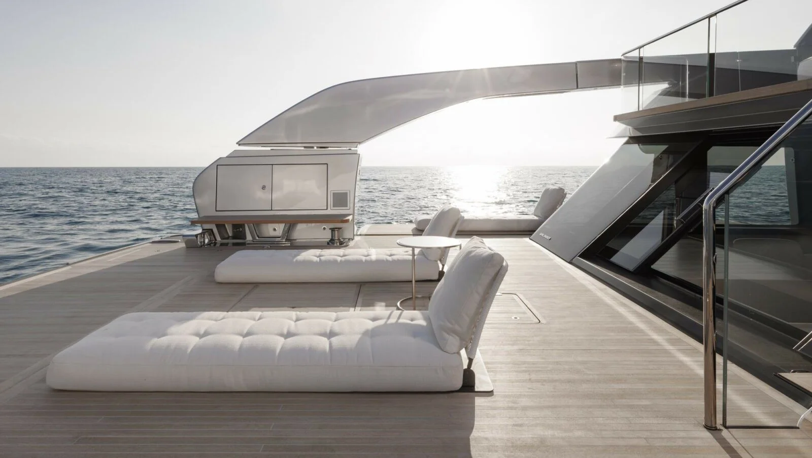 At anchor the aft open deck converts into a beach area. The "arch" is an in-built crane for launching the tender