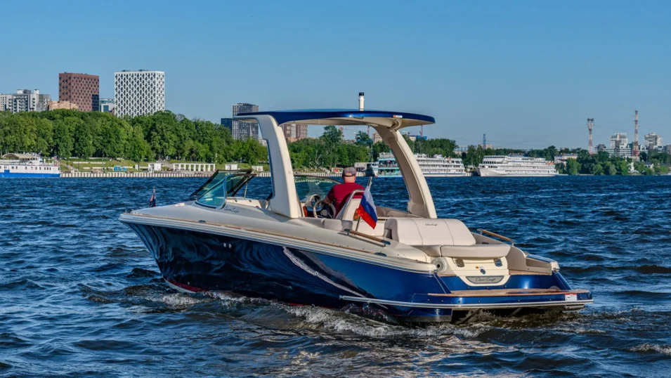 The Launch 28 GT's hull and hardtop are painted Midnight Blue with a red waterline stripe